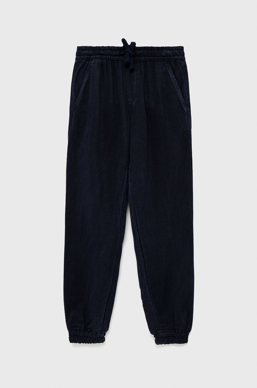 Dětské kalhoty Guess tmavomodrá barva, hladké - námořnická modř -  100% Lyocell