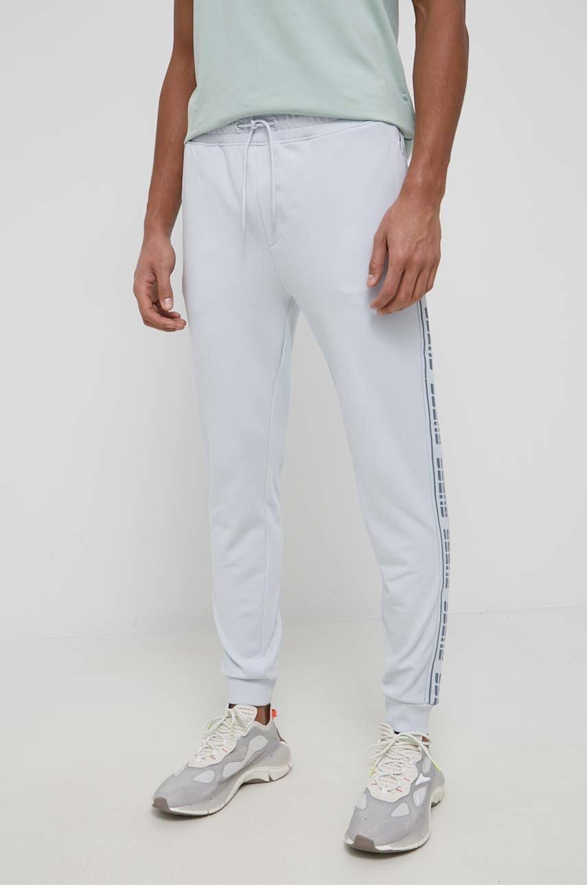 

Брюки Guess мужские цвет розовый с аппликацией