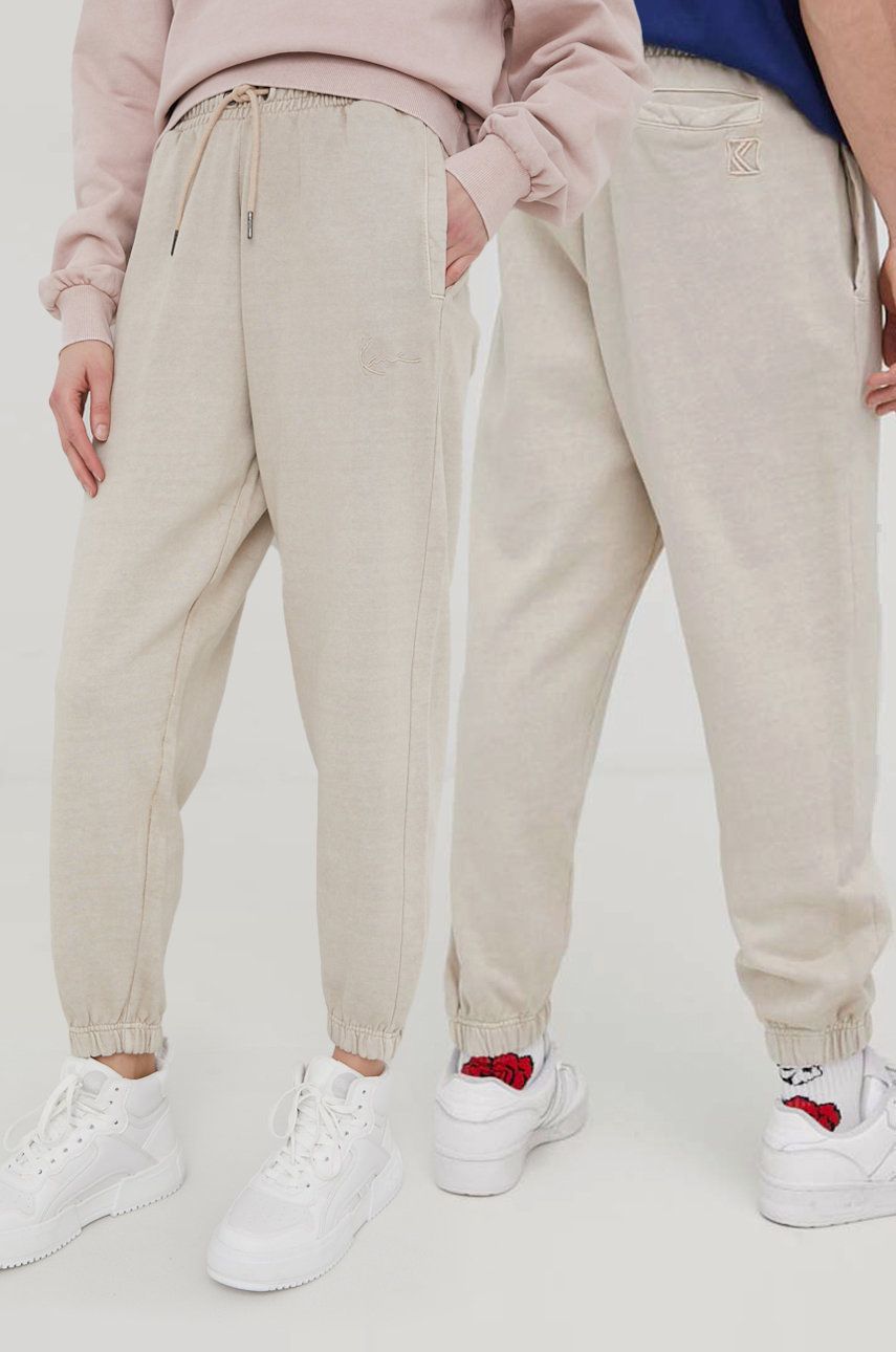 Karl Kani spodnie dresowe bawełniane kolor beżowy gładkie