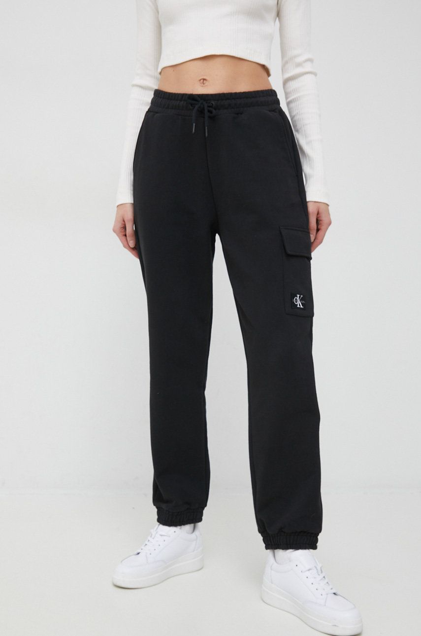 Levně Bavlněné tepláky Calvin Klein Jeans černá barva