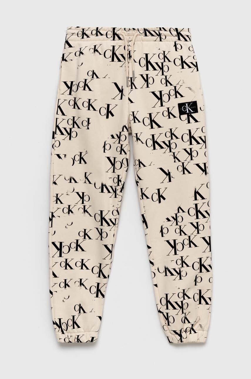 

Детски спортен панталон Calvin Klein Jeans в бежово с десен, Бежов