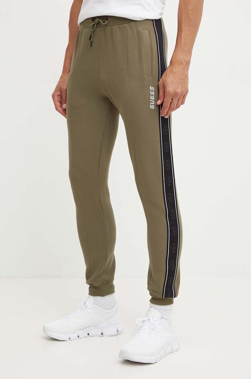 Levně Tepláky Guess zelená barva, s potiskem