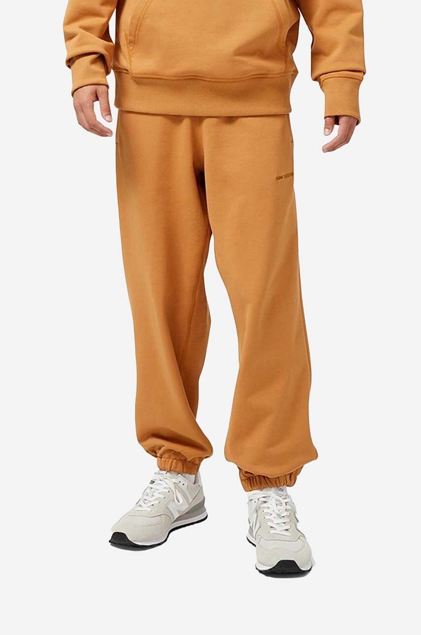 New Balance pantaloni de trening din bumbac culoarea portocaliu, neted