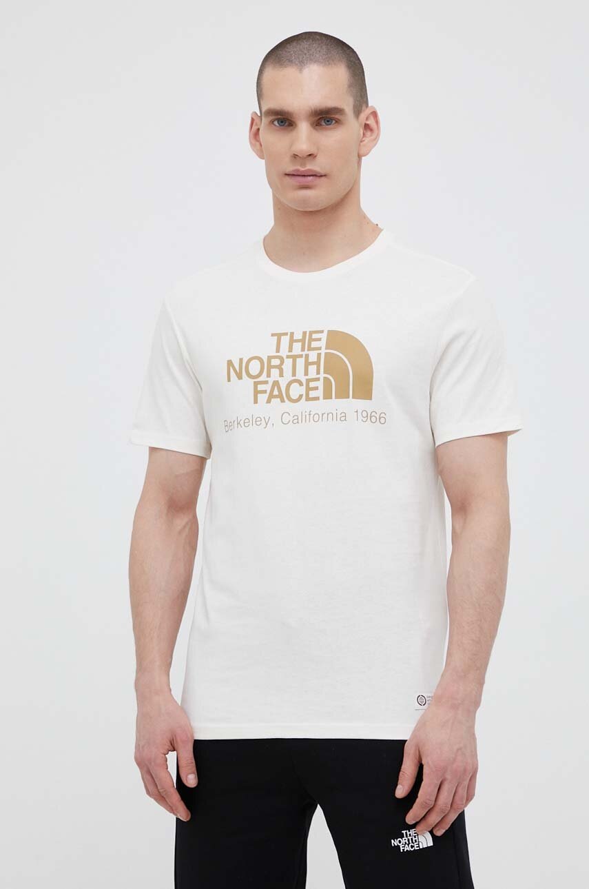 

Бавовняна футболка The North Face колір бежевий з принтом