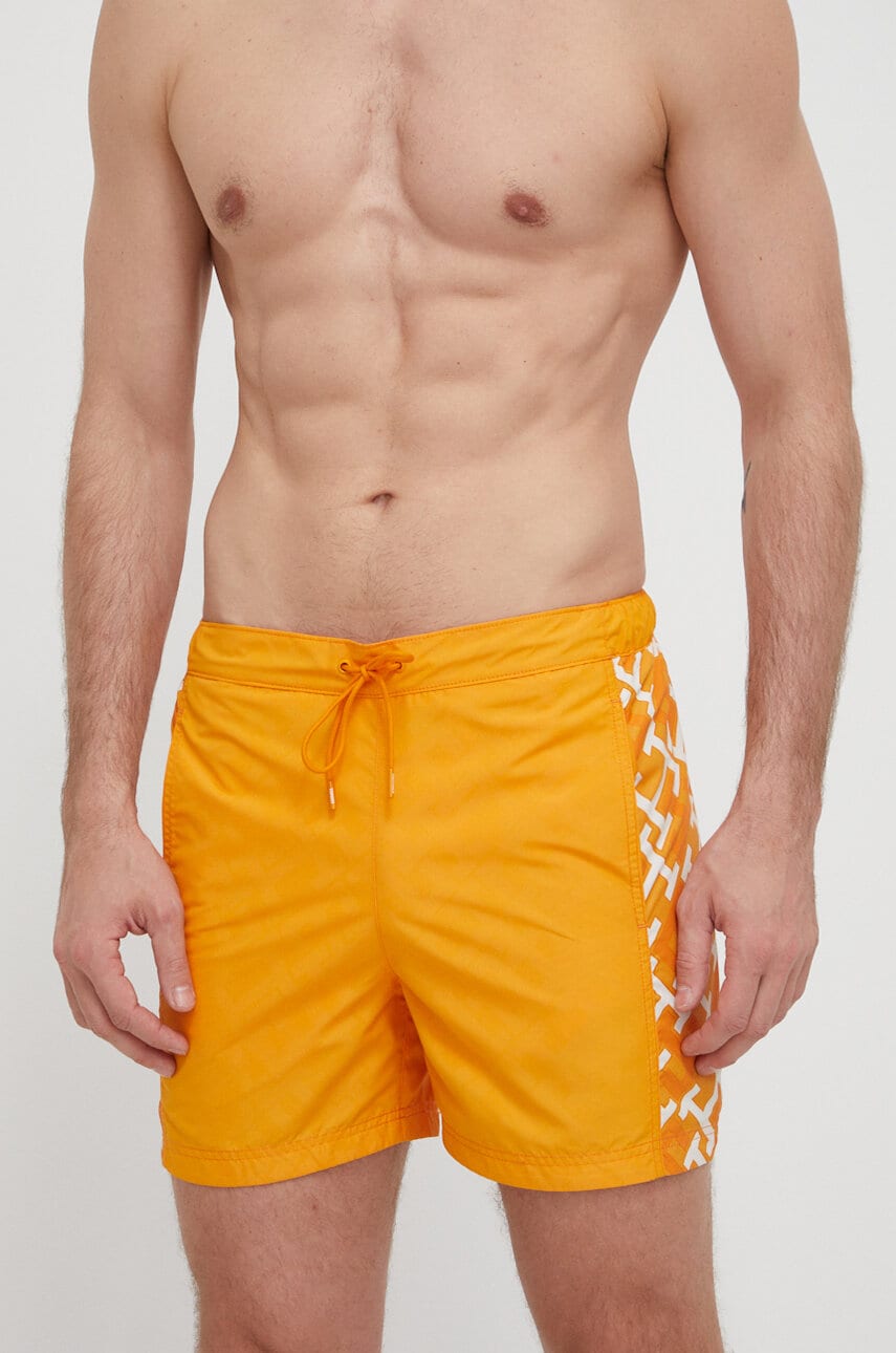 Levně Plavkové šortky Tommy Hilfiger oranžová barva, UM0UM03211
