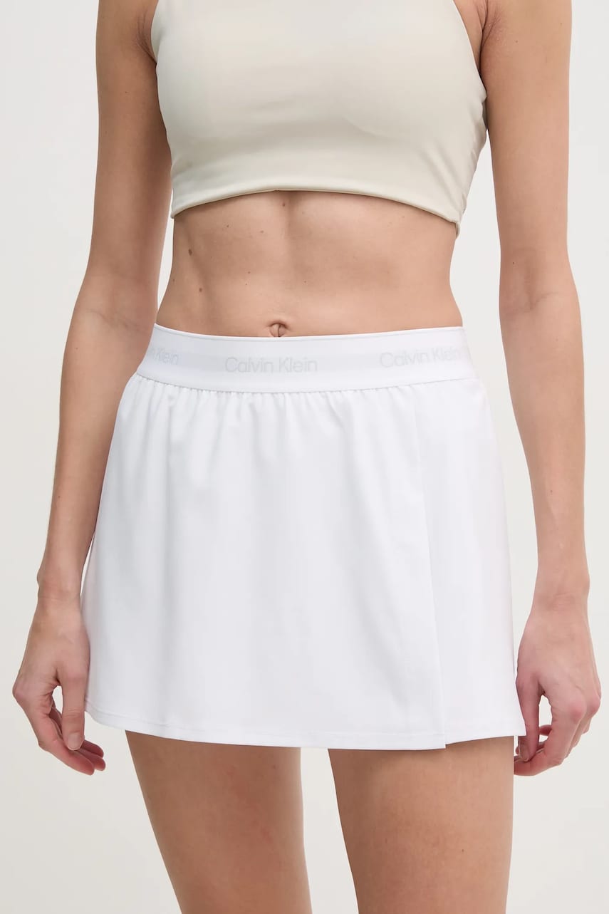 Levně Sportovní sukně Calvin Klein Performance bílá barva, mini