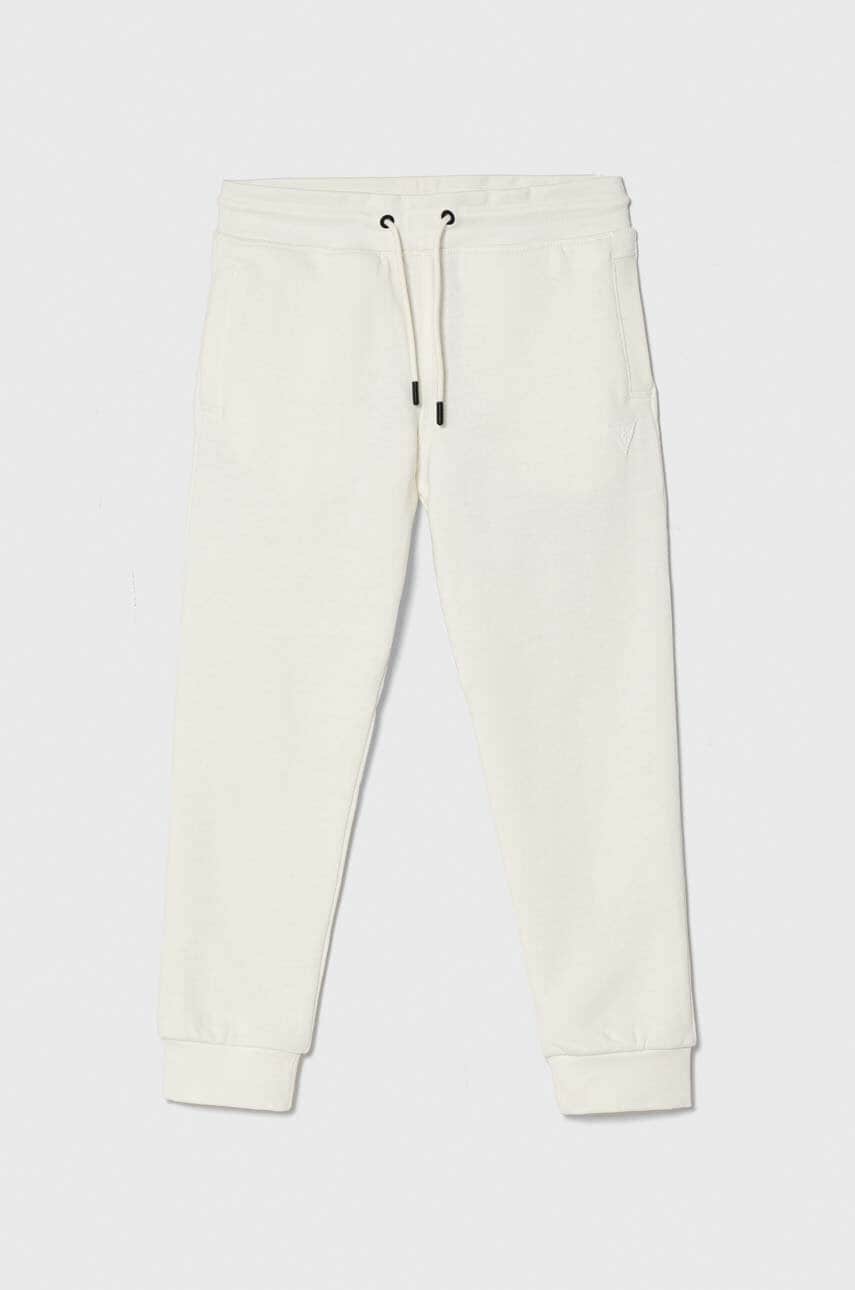 Levně Dětské tepláky Guess bílá barva, hladké