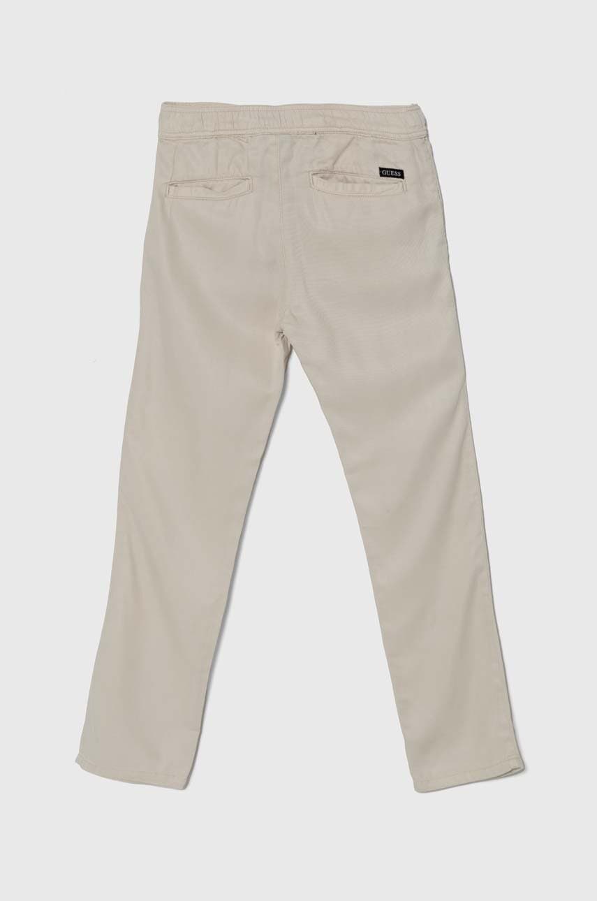 Дитячі штани Guess колір бежевий однотонні Дитячі штани Guess колір бежевий однотонні