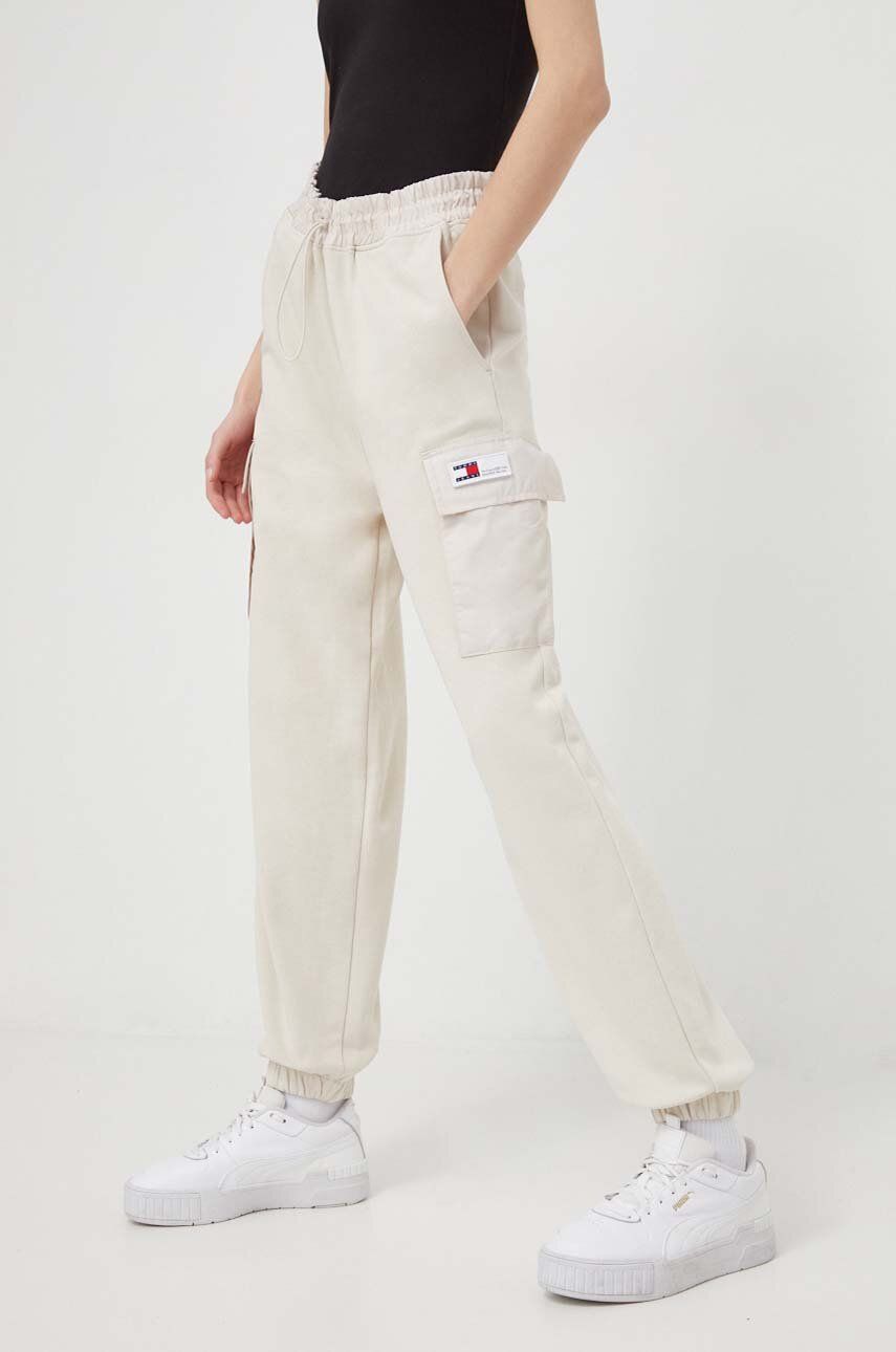 Levně Tepláky Tommy Jeans béžová barva, hladké, DW0DW17313