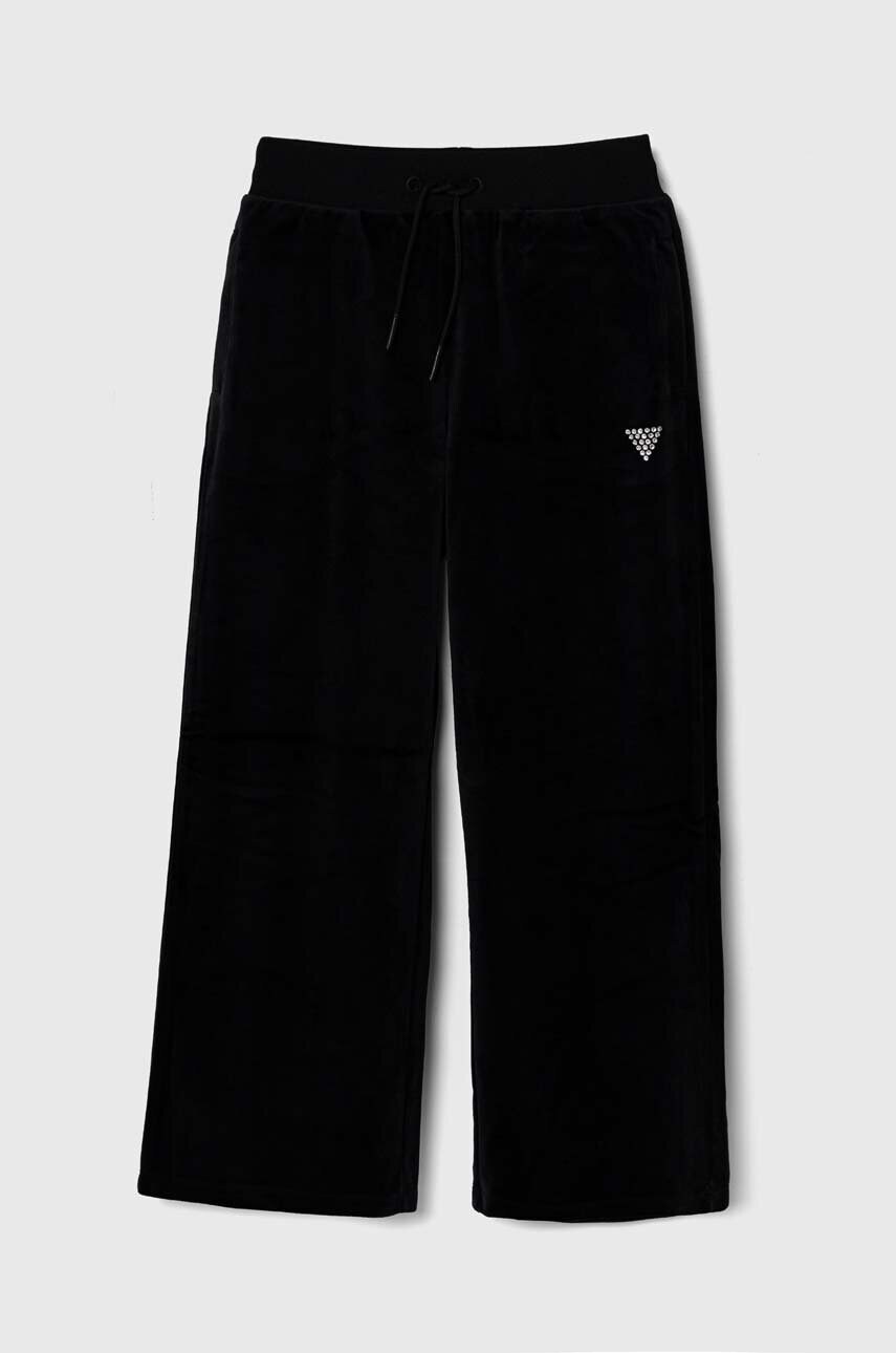 Levně Dětské velurové tepláky Guess černá barva
