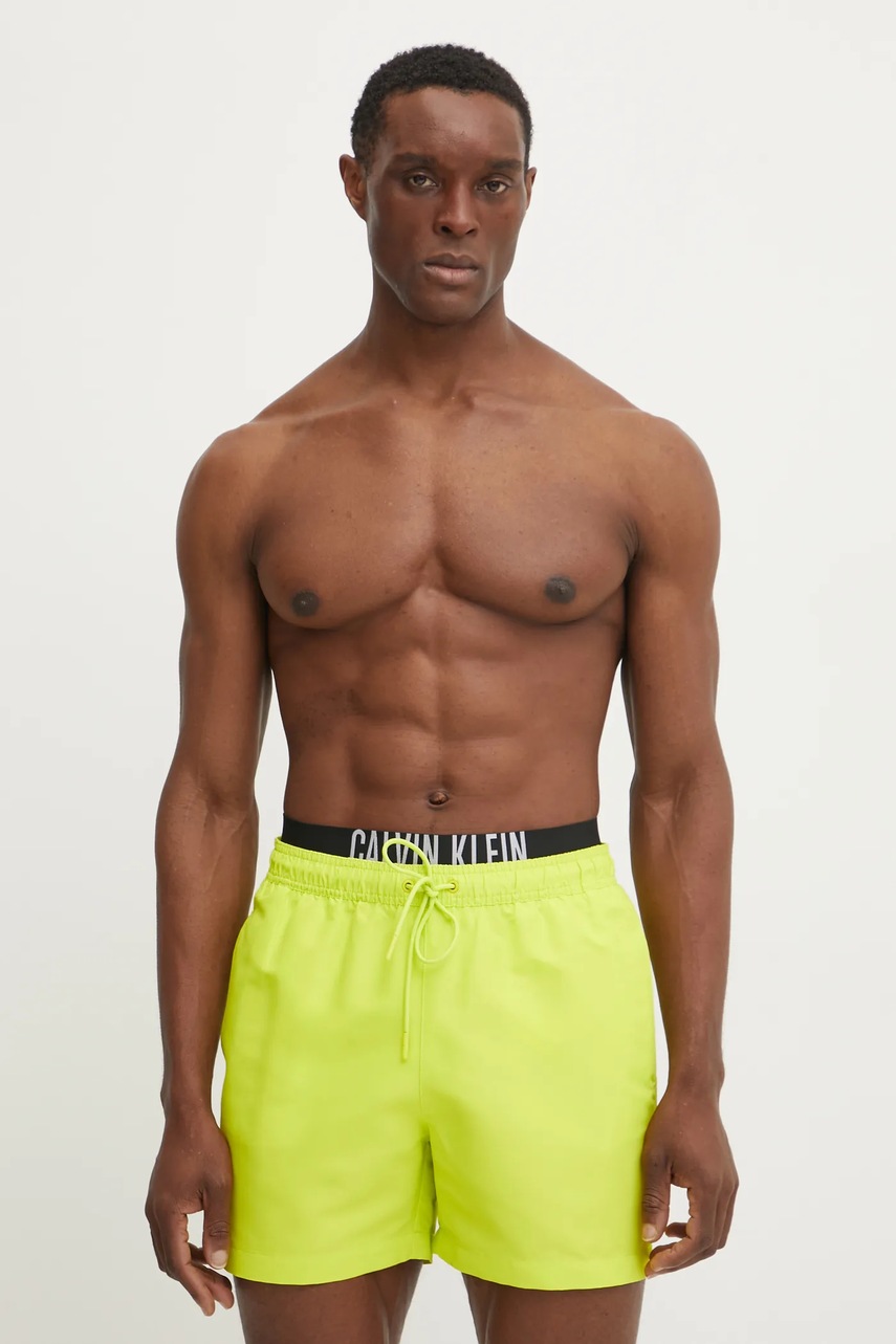 Levně Plavkové šortky Calvin Klein žlutá barva, KM0KM01093