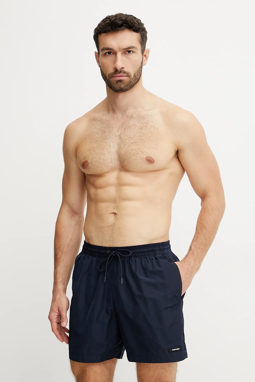 Levně Plavkové šortky Calvin Klein tmavomodrá barva, KM0KM01111