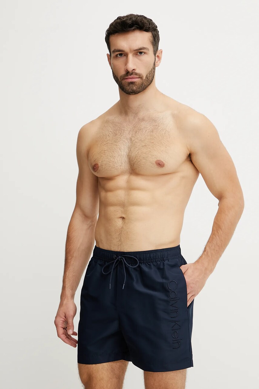 Levně Plavkové šortky Calvin Klein tmavomodrá barva, KM0KM01166