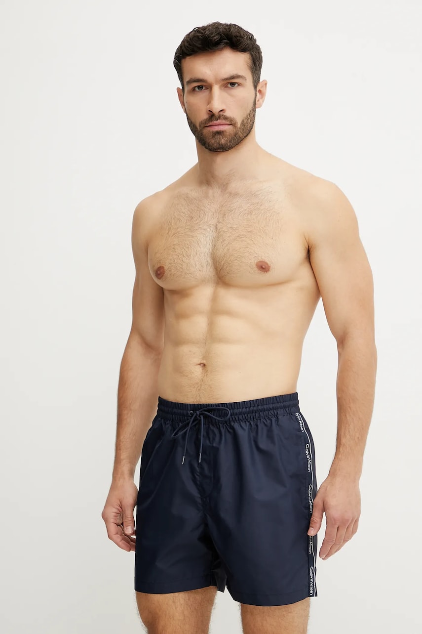 Levně Plavkové šortky Calvin Klein tmavomodrá barva, KM0KM01109