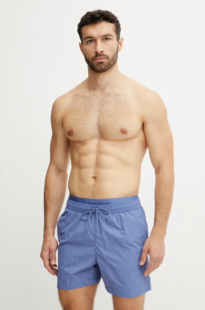 Levně Plavkové šortky Calvin Klein modrá barva, KM0KM01104