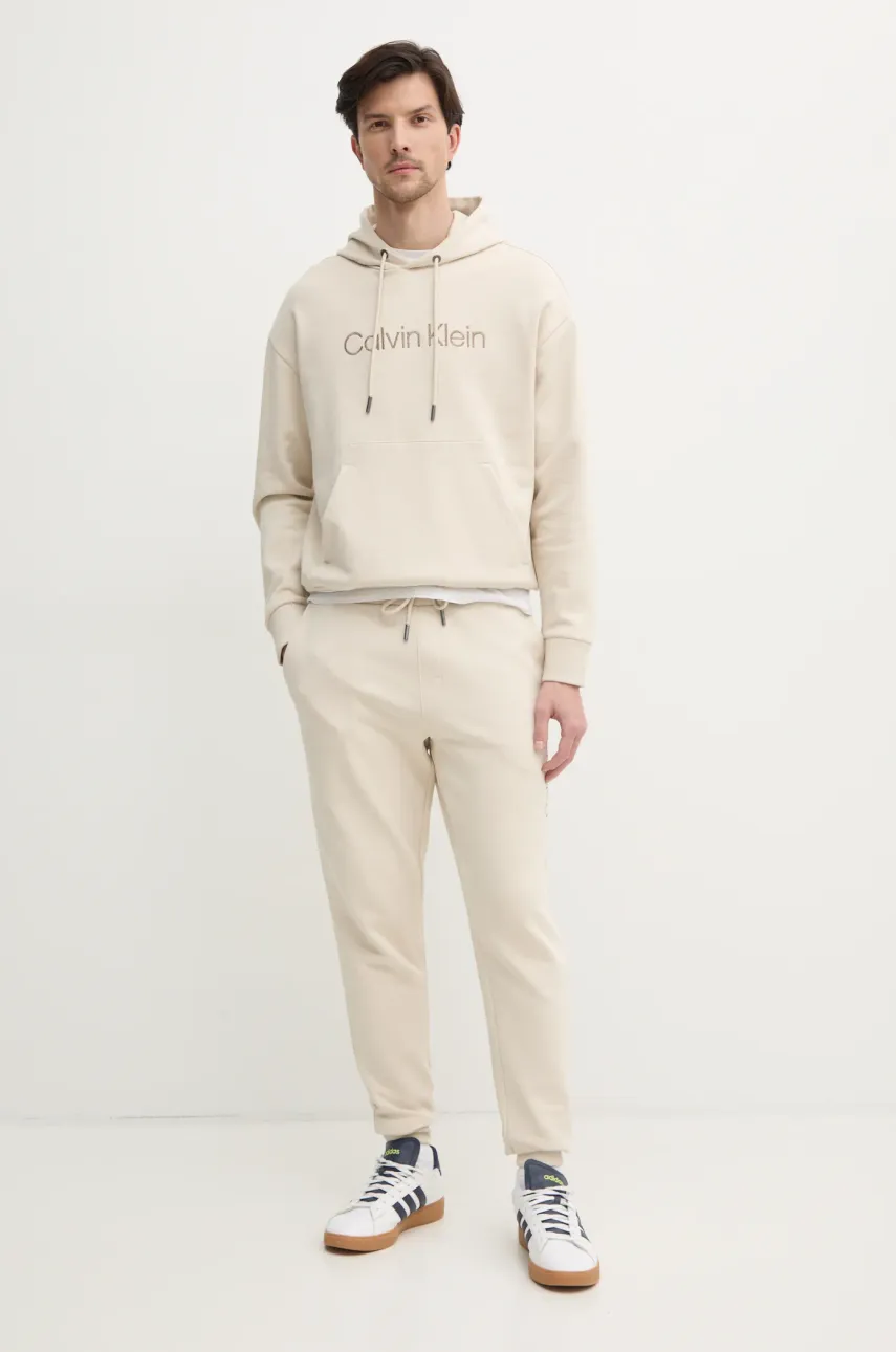 Хлопковая кофта Calvin Klein мужская цвет бежевый с капюшоном с аппликацией K10K114257 Хлопковая кофта Calvin Klein мужская цвет бежевый с капюшоном с аппликацией K10K114257