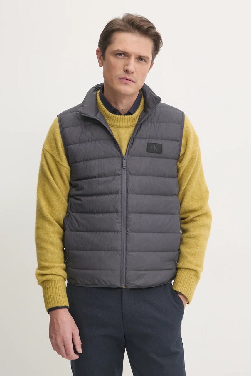 Levně Péřová vesta Calvin Klein Jeans šedá barva, J30J326718