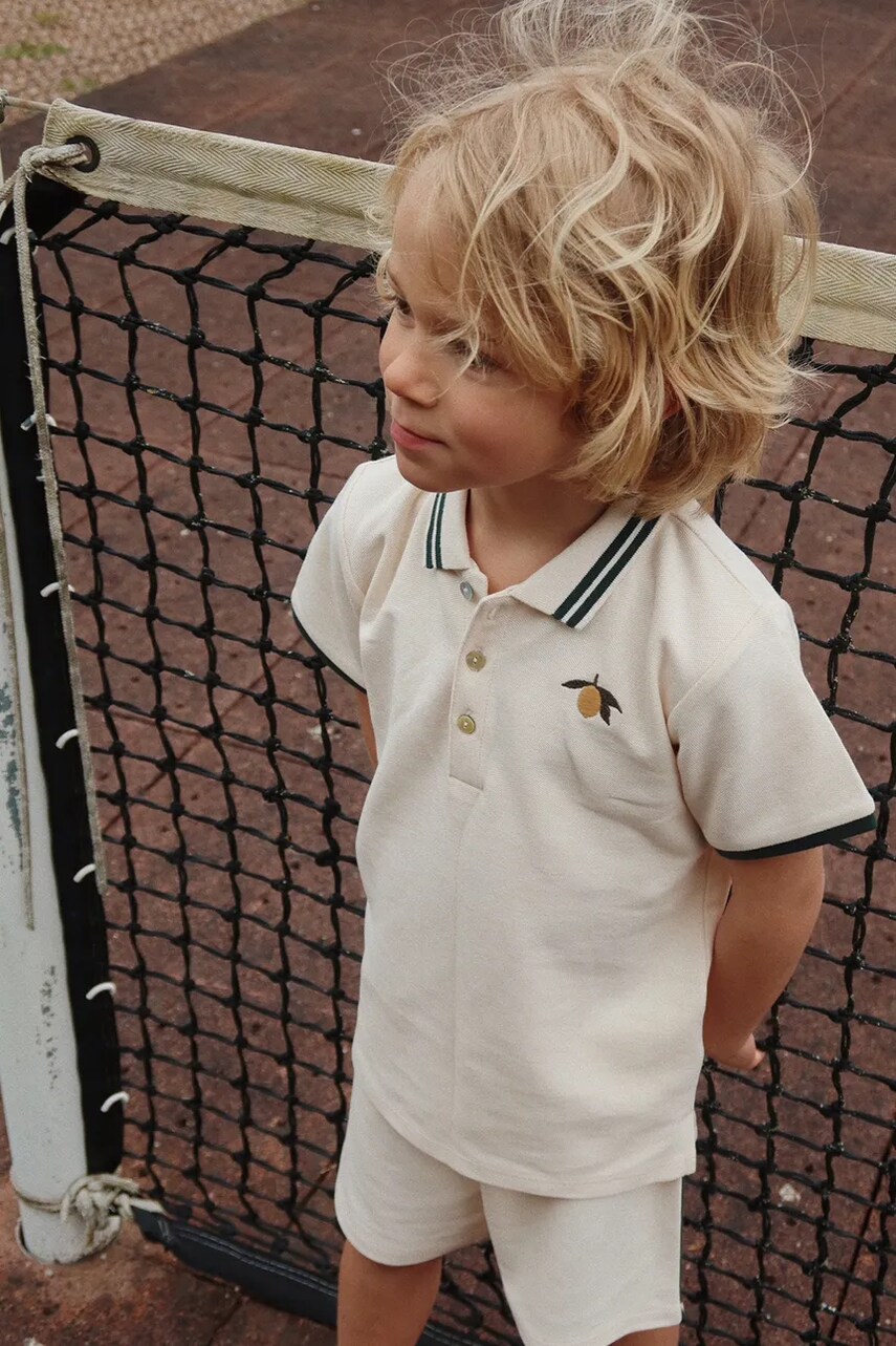 Levně Dětská bavlněná polokošile Konges Sløjd FLORIAN POLO SHIRT GOTS béžová barva, s aplikací, KS102412