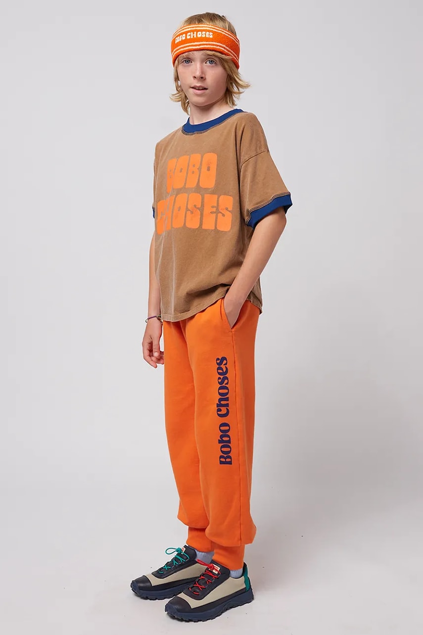 Bobo Choses pantaloni de trening din bumbac pentru copii culoarea portocaliu, cu imprimeu, 125AC140 Bobo Choses pantaloni de trening din bumbac pentru copii culoarea portocaliu, cu imprimeu, 125AC140
