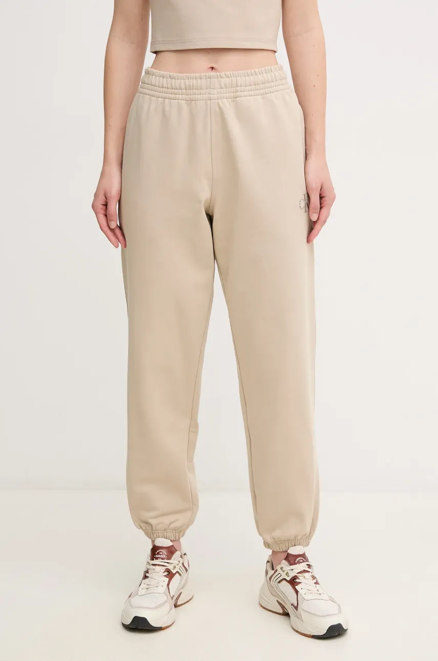 Levně Tepláky Calvin Klein Jeans dámské, béžová barva, hladké, LV047B235G