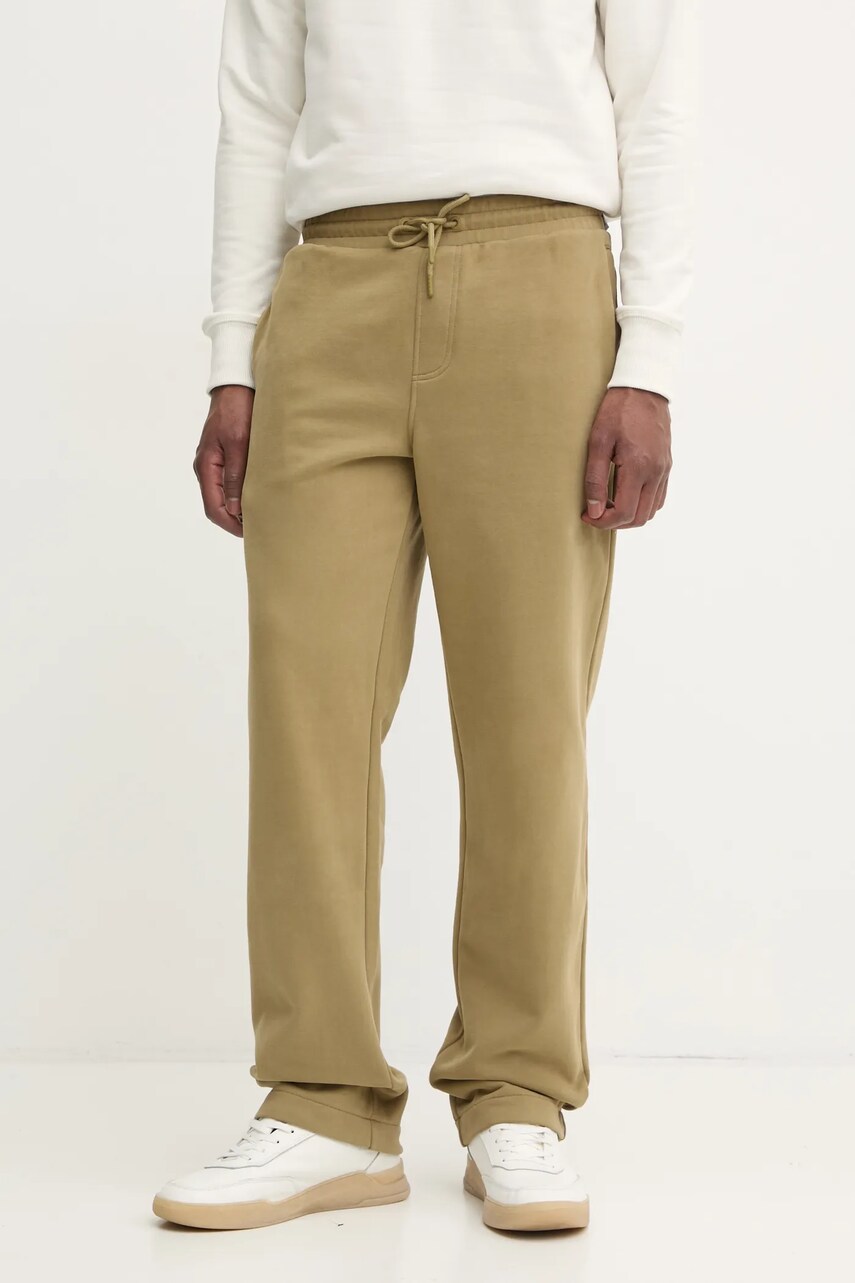Levně Bavlněné tepláky Calvin Klein Jeans zelená barva, J30J326749