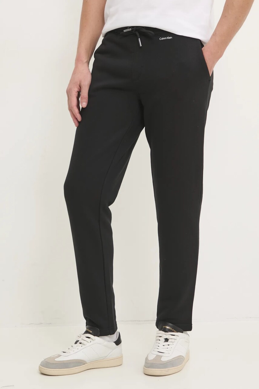 Levně Tepláky Calvin Klein černá barva, hladké, K10K113654