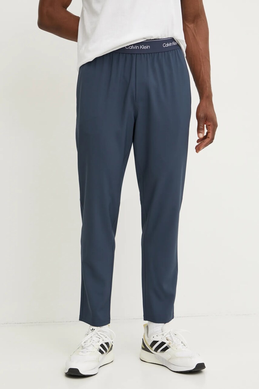 Levně Tréninkové kalhoty Calvin Klein Performance modrá barva, s potiskem, LVGMS5P643