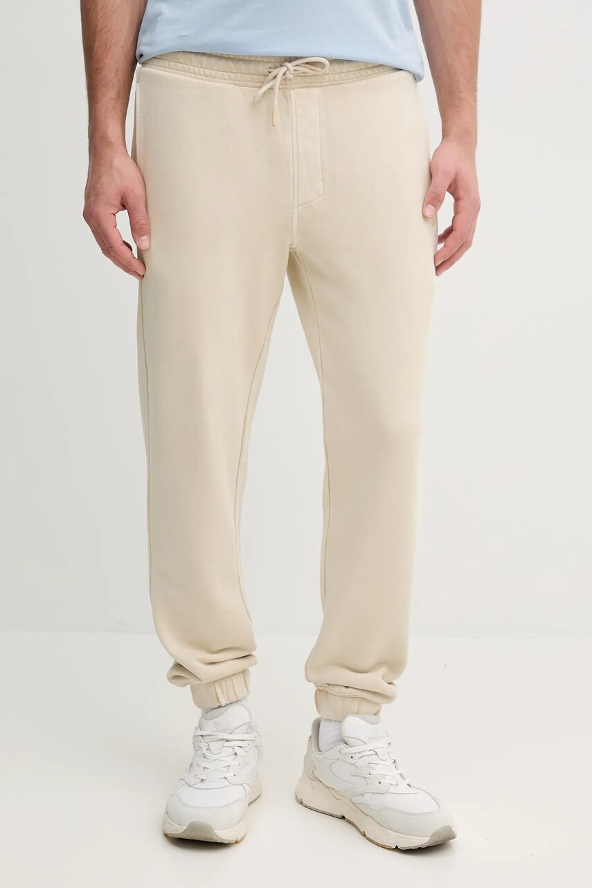 Levně Bavlněné tepláky Calvin Klein Jeans béžová barva, J30J327252