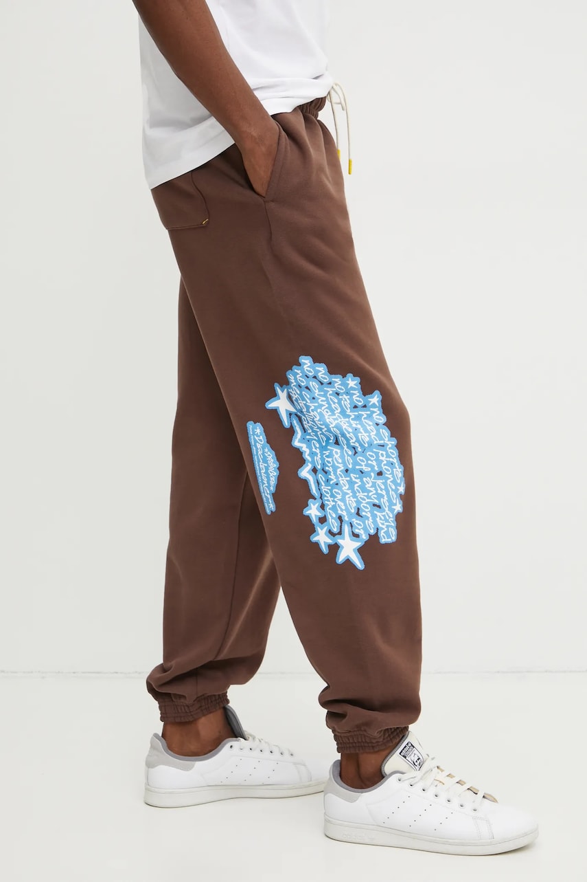 Puma pantaloni de trening din bumbac barbati, culoarea maro, cu imprimeu, 630295 Puma pantaloni de trening din bumbac barbati, culoarea maro, cu imprimeu, 630295